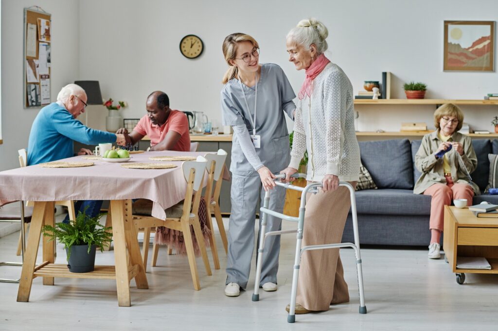Volunteer caring about senior people in nursing home